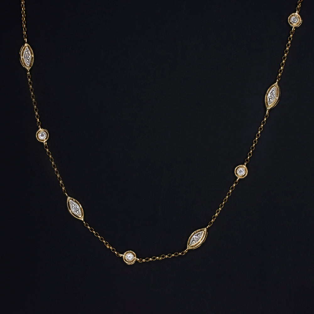 Vintage 14k yellow gold diamond station necklace with round and marquise settings, 0.90ct, 38 inches long.
