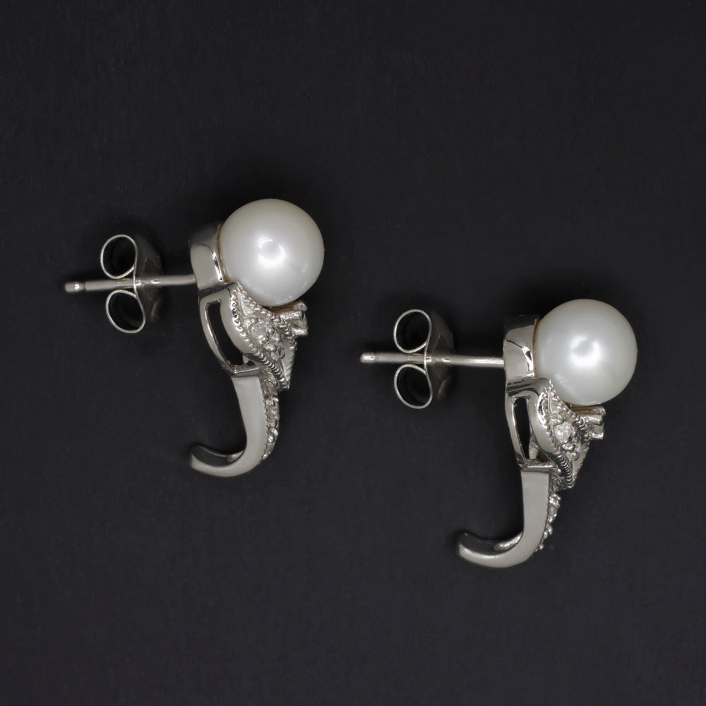 Vintage pearl diamond earrings in 14k white gold, retro floral half hoop design with lustrous pearls and diamond accents.