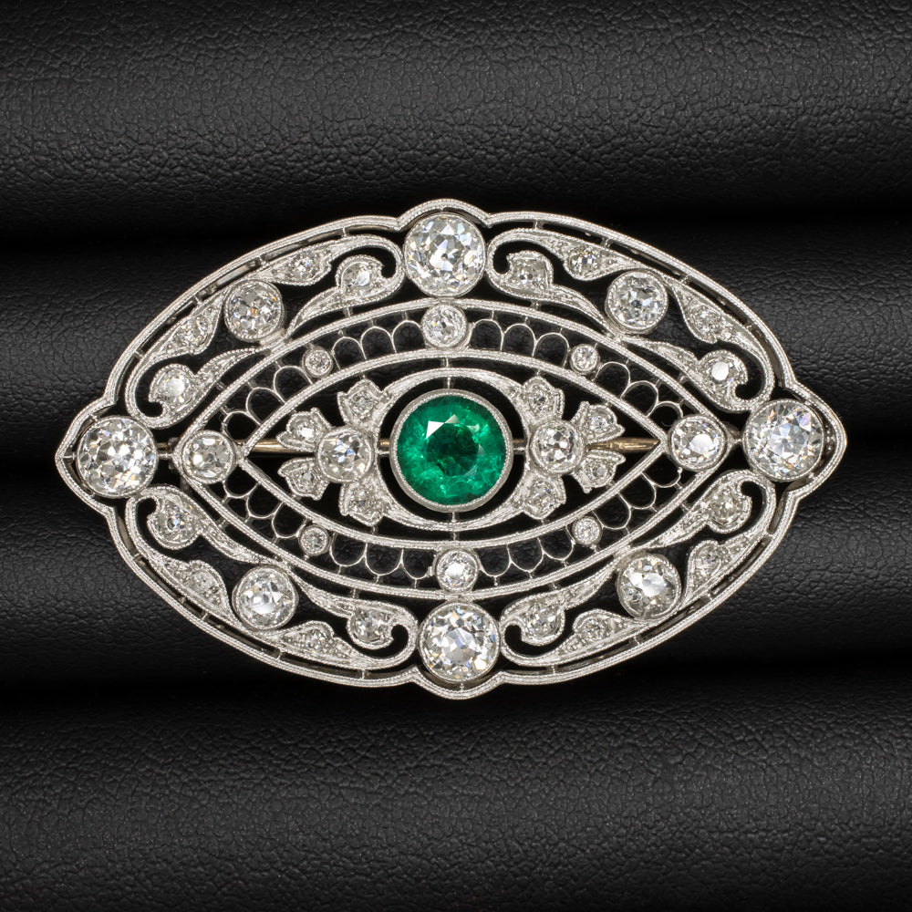 Vintage Art Deco emerald diamond pin pendant in platinum with intricate filigree design.