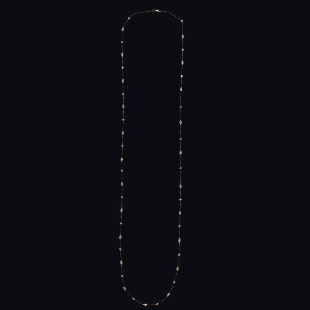 Vintage diamond station necklace in 14k yellow gold, 38 inches long, featuring round and marquise diamonds on a dainty chain.