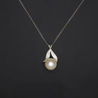 Pearl flower pendant necklace in 14k white gold with dainty chain and 8.4mm lustrous white pearl, vintage style.