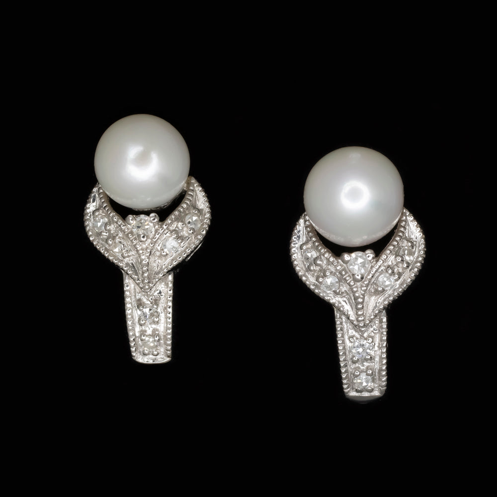 Vintage pearl diamond earrings in 14k white gold with romantic floral design and lustrous pearls, measuring 15.6 x 8.2mm.