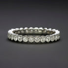 0.56ct natural diamond wedding ring in 14k white gold band with milgrain bezels and full eternity design.