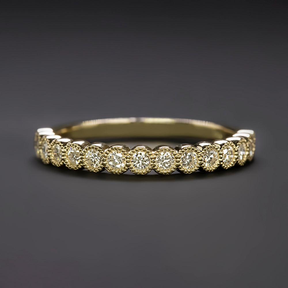 Elegant diamond eternity band featuring vibrant yellow diamonds set in a classic gold setting, perfect for weddings or special occasions.