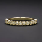Elegant diamond eternity band featuring vibrant yellow diamonds set in a classic gold setting, perfect for weddings or special occasions.
