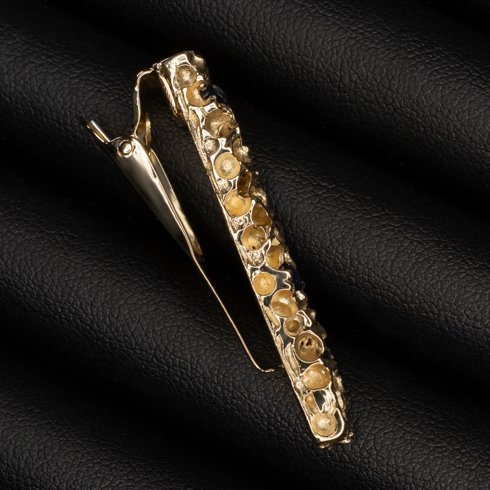 Vintage Cartier 14k yellow gold tie bar with sapphire cabochons, 1970s design, charming nugget texture.