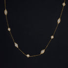 Vintage 14k yellow gold diamond station necklace with round and marquise settings, 0.90ct, 38 inches long.