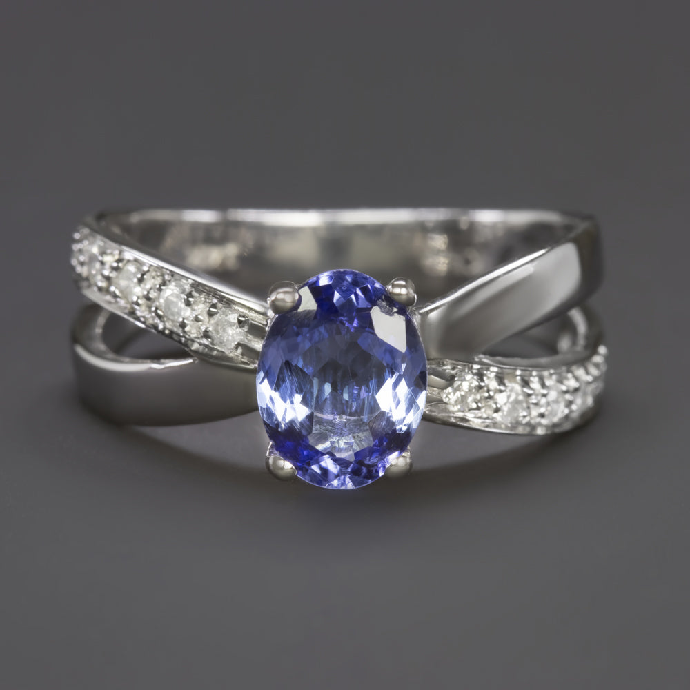 Elegant 1 carat tanzanite ring in 14k white gold with diamond-accented criss cross split shank design.