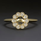 Natural diamond ring setting in 14k yellow gold with scalloped halo and space for 5mm round center stone.